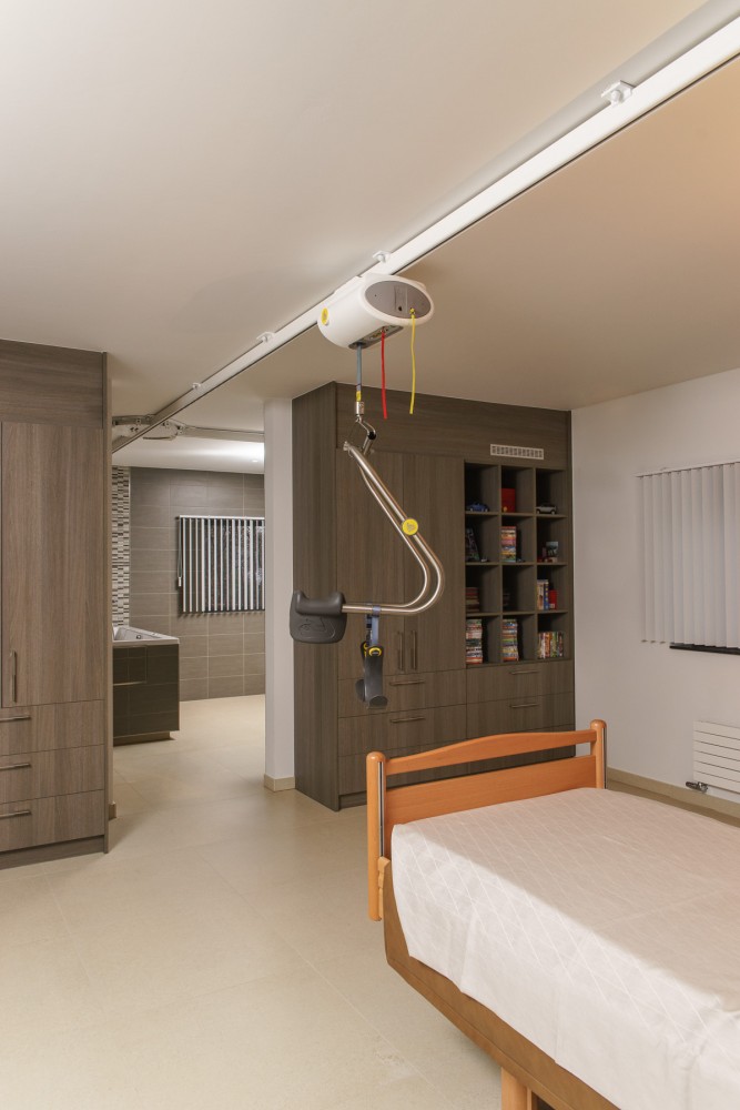 SureHands ceiling lift in patient's room from Lifeway Mobility