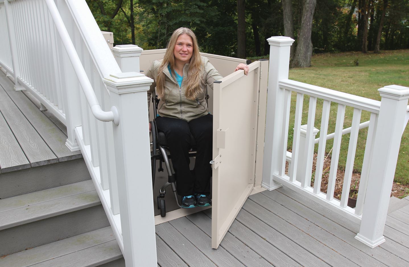 woman in wheelchair safely exits platform lift onto deck