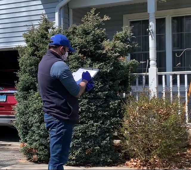 Lifeway Mobility consultant writes measurements on-site for modular wheelchair ramp configuration