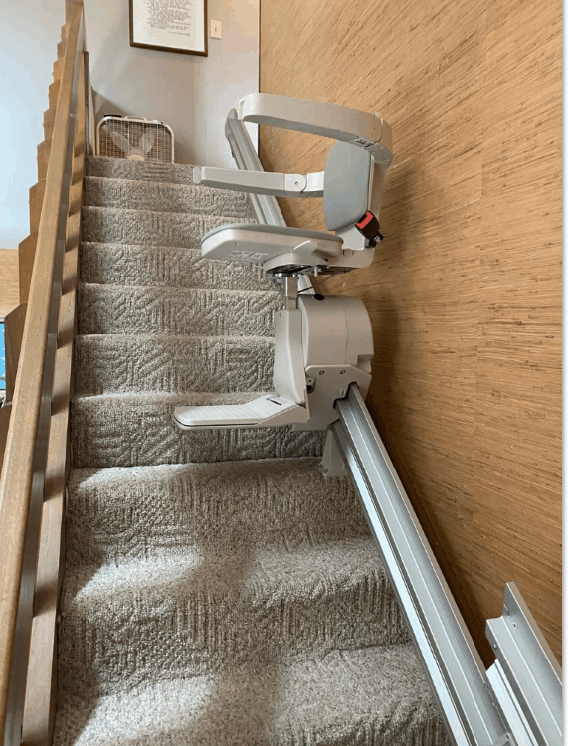 Bruno Elan stairlift halfway up the stairs in home in Indiana
