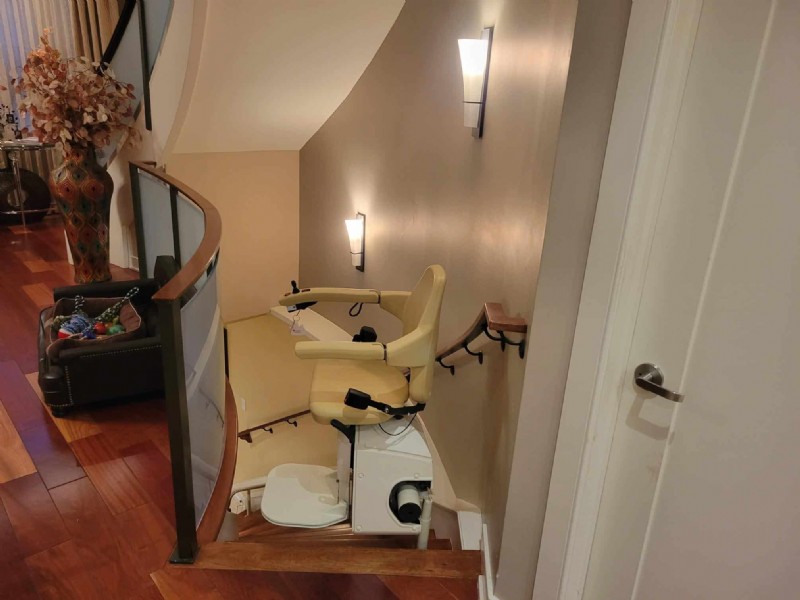 Handicare curved stairlift at top landing of basement stairs in Philadelphia home