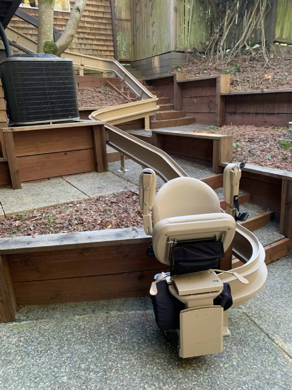outdoor Bruno curved stairlift in San Francisco with components folded up