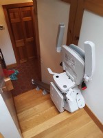 Bruno-Elan-stairlift-components-folded-up-at-top-landing-in-home-in-Weston-Massachusetts.jpg