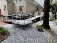aluminum wheelchair ramp installed over pavers and rocks outside of Philadelphia home