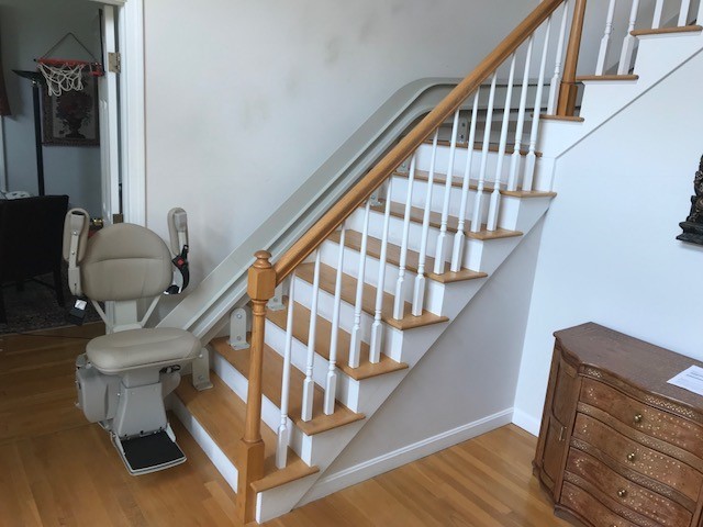 Bruno curved stairlift at bottom landing with components folded up