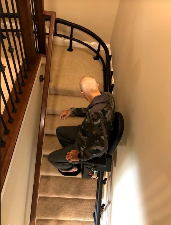 Lifeway-Mobility-Minnesota-customer-riding-his-new-Harmar-Helix-curved-stairlift.JPG